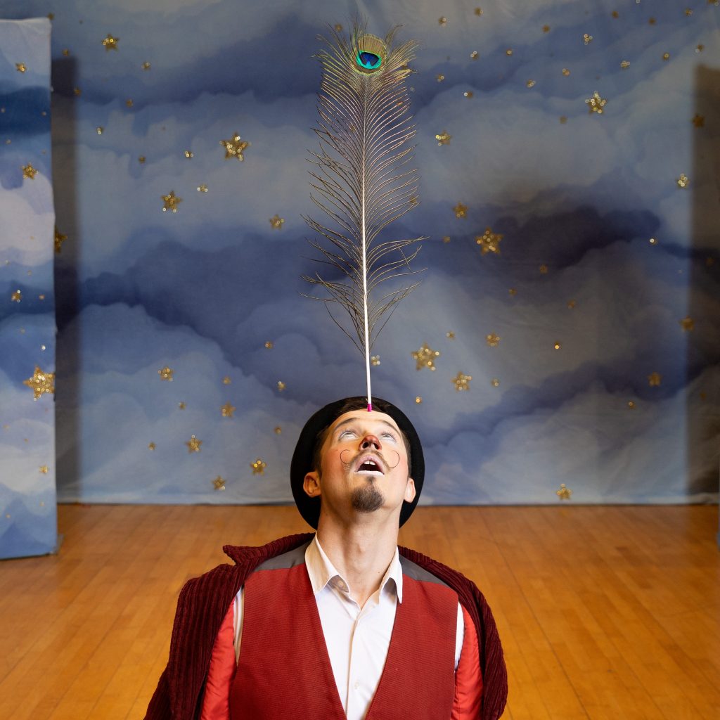 A man is balancing a father on his forehead.