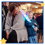 Two audience members - an adult and a child - enjoying a circus starr performance